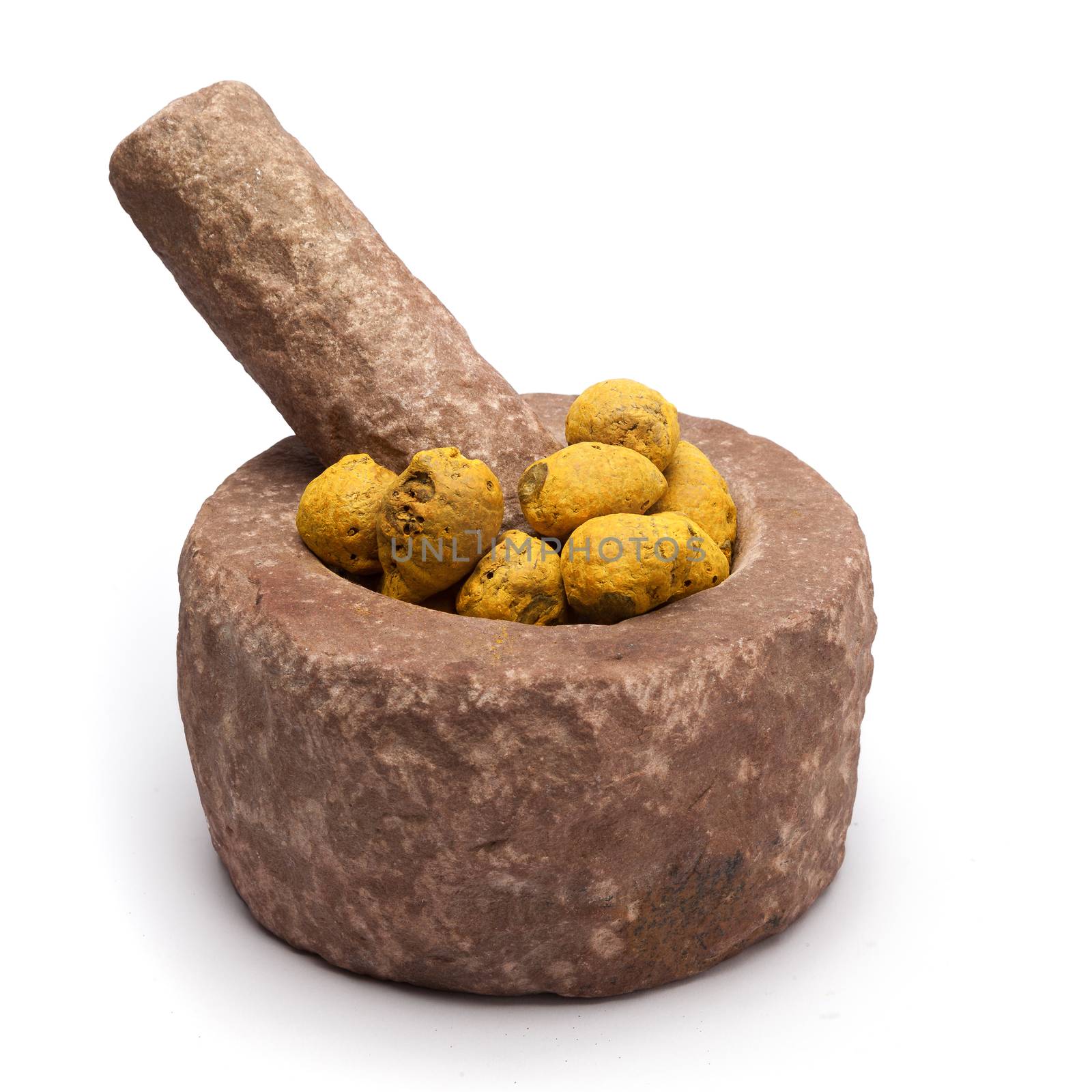 Organic Round Turmeric or Haldi (Curcuma longa) in mortar with pestle, isolated on white background.