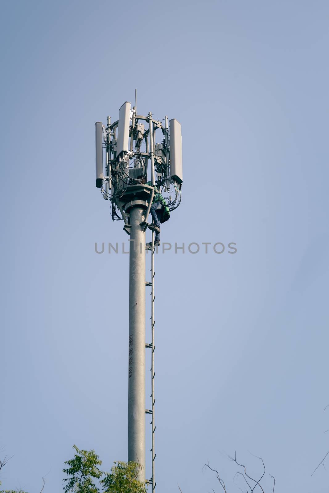 An Indian man working on Telecommunication tower. Dec 13, 2015. Kanpur, India.