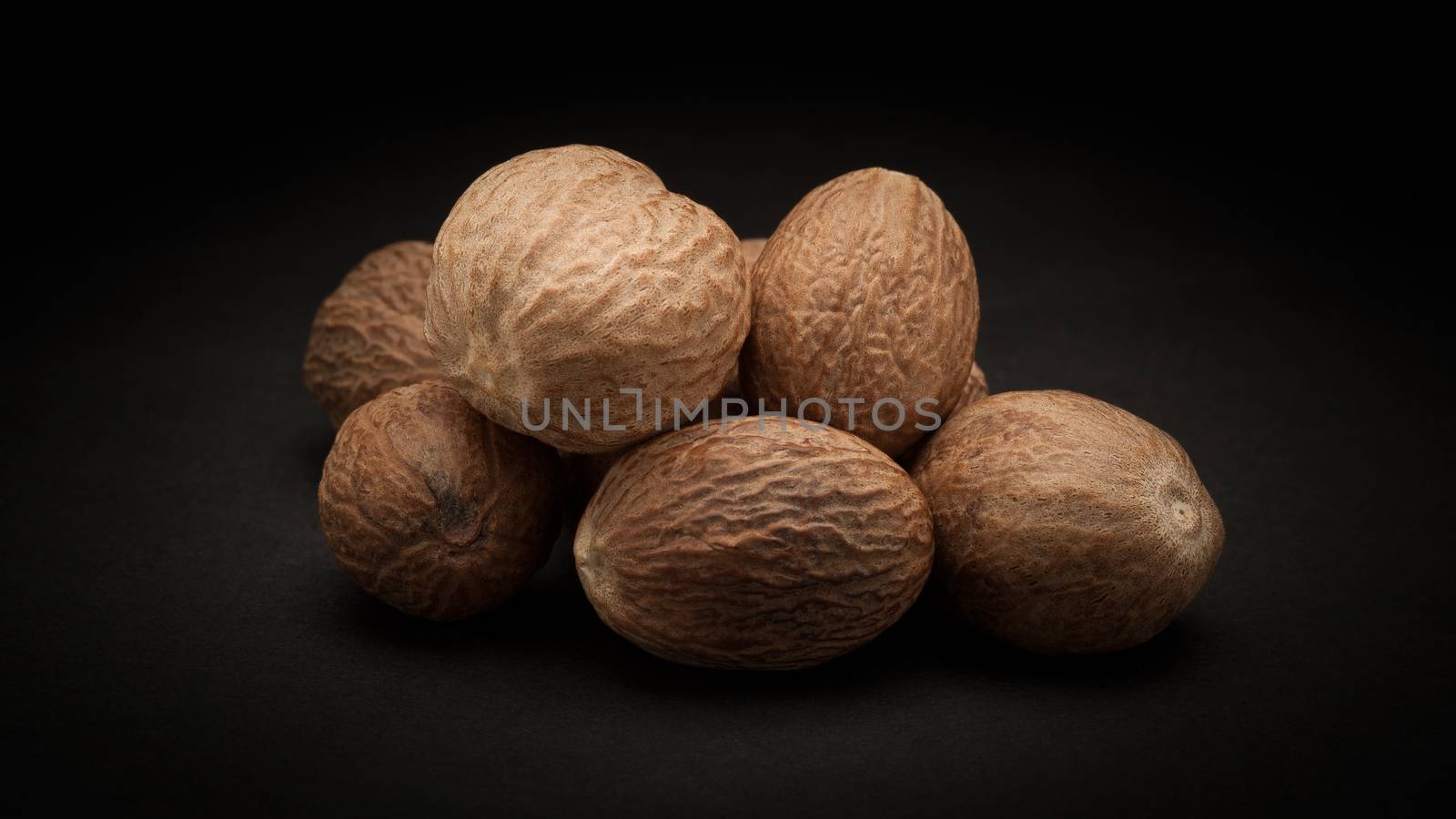 Pile of Organic Nutmeg Seed (Myristica fragrans) by ziprashantzi