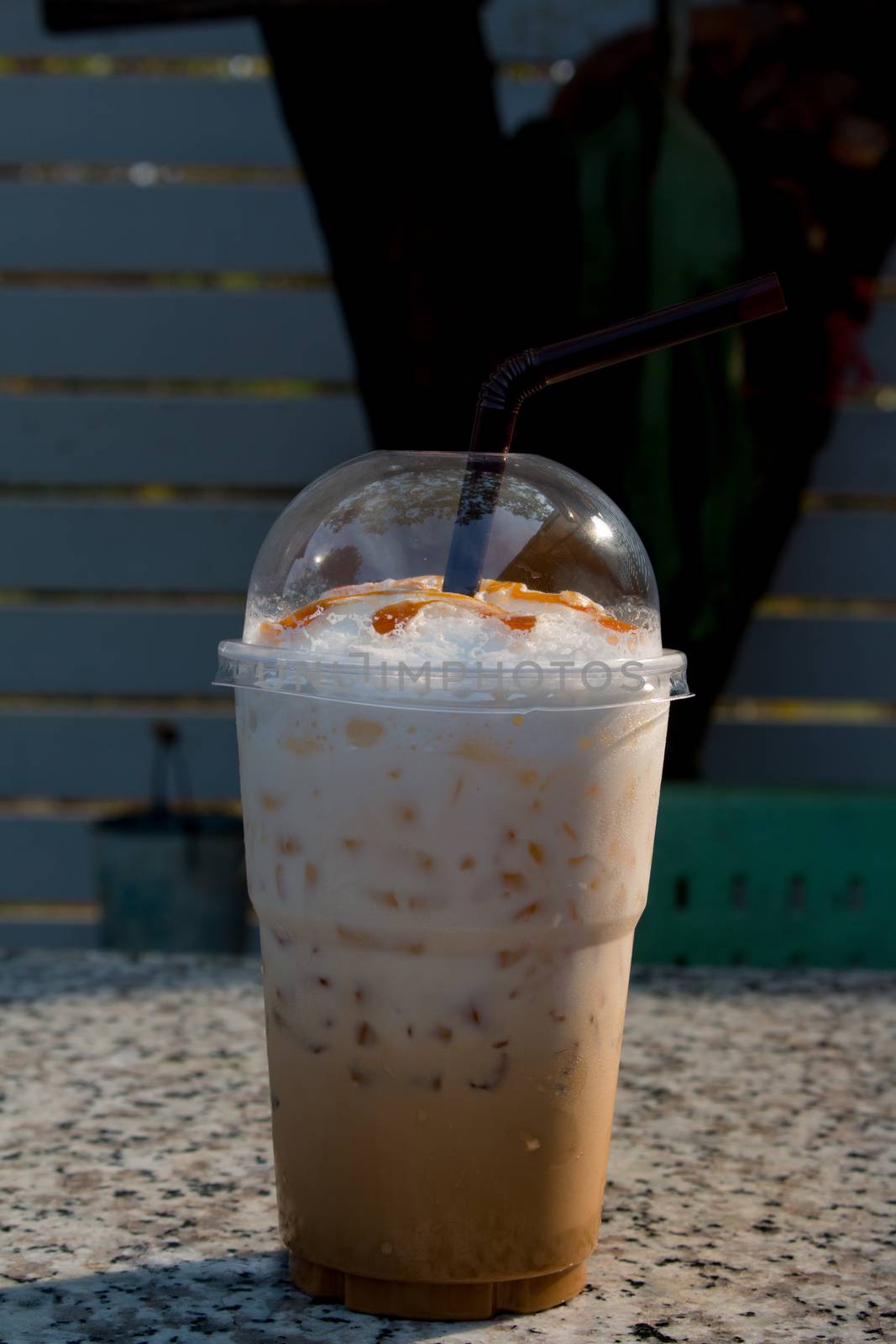 Iced coffee with straw in plastic cup