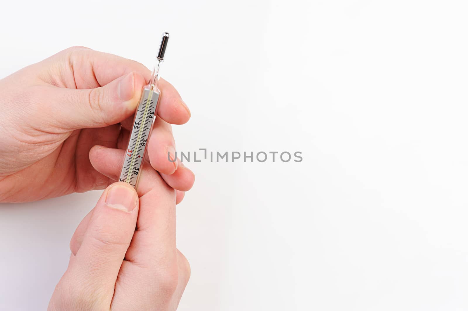glass thermometer in hands on hite background