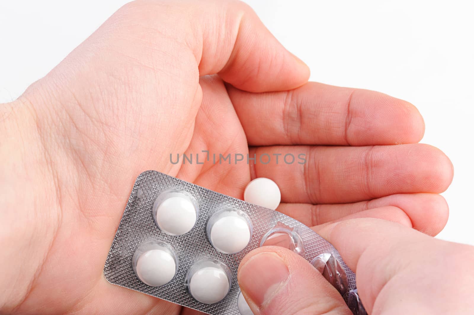 close get white pill in hand from pack 