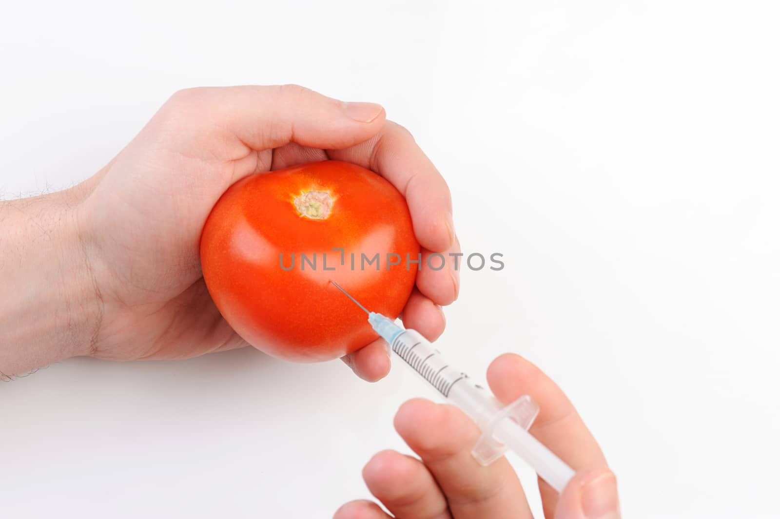 tomato shot with syringe on white background