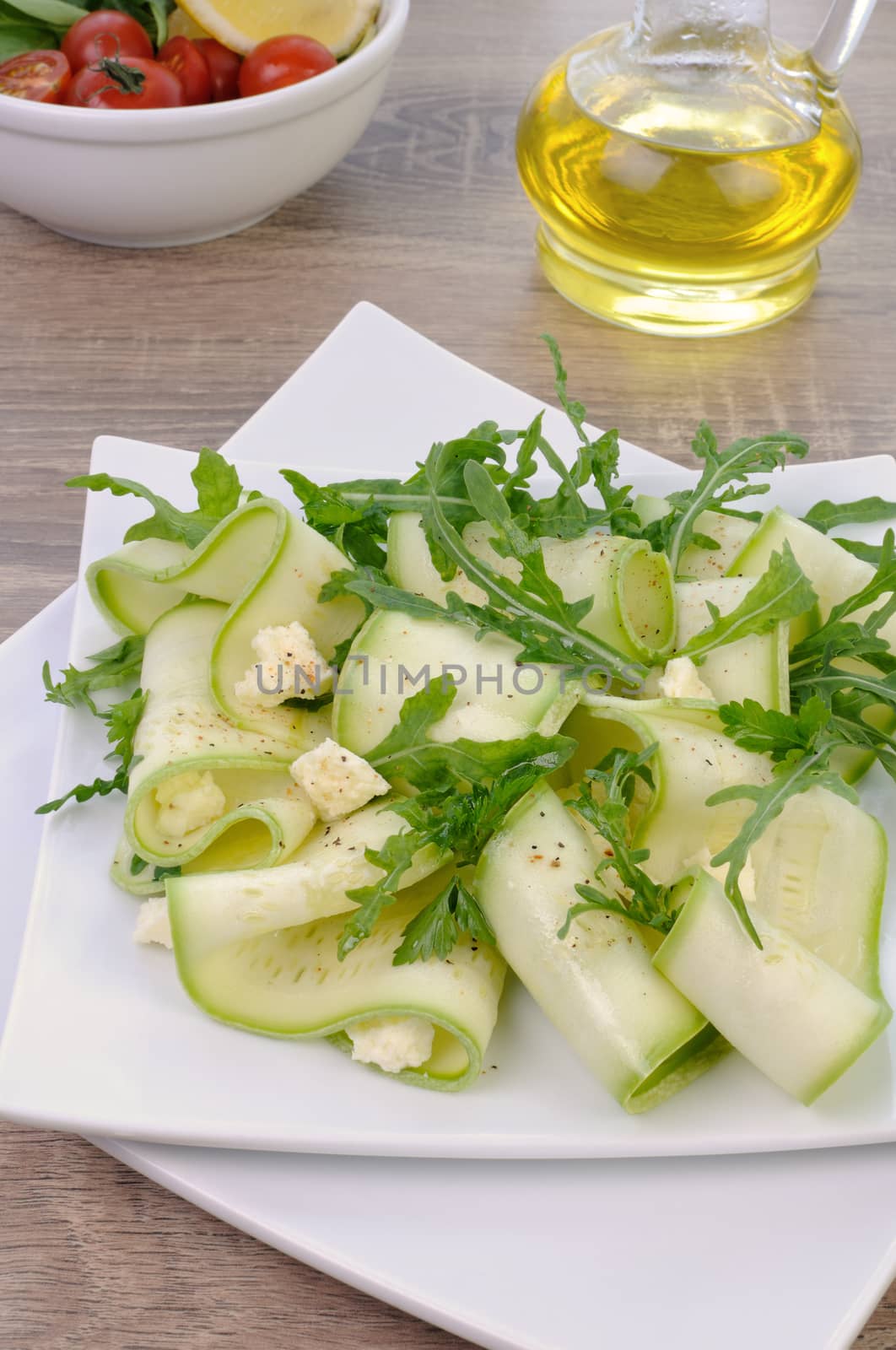 Salad from zucchini ribbon with arugula and feta