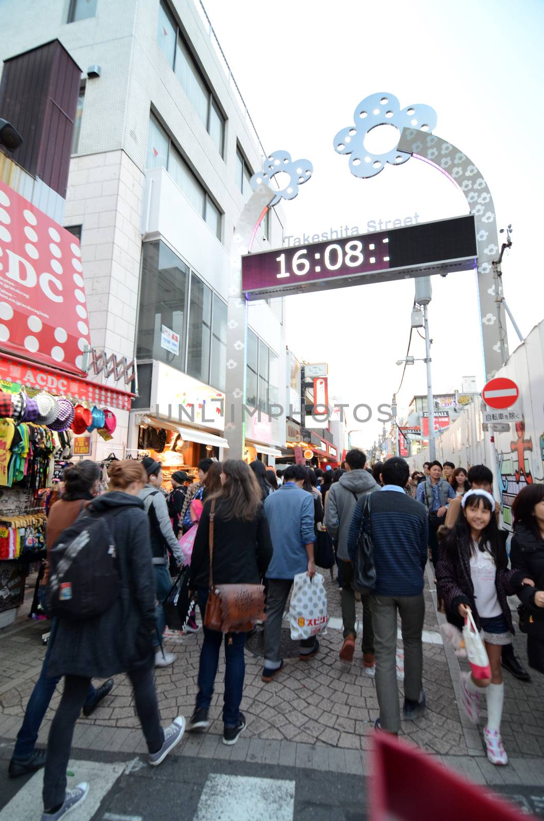 Tokyo, Japan - November 24, 2013: Crowd at Takeshita street Harajuku on November 24, 2013 in Tokyo, Japan. Takeshita street is a street lined with fashion, cafes and restaurants in Harajuku. 