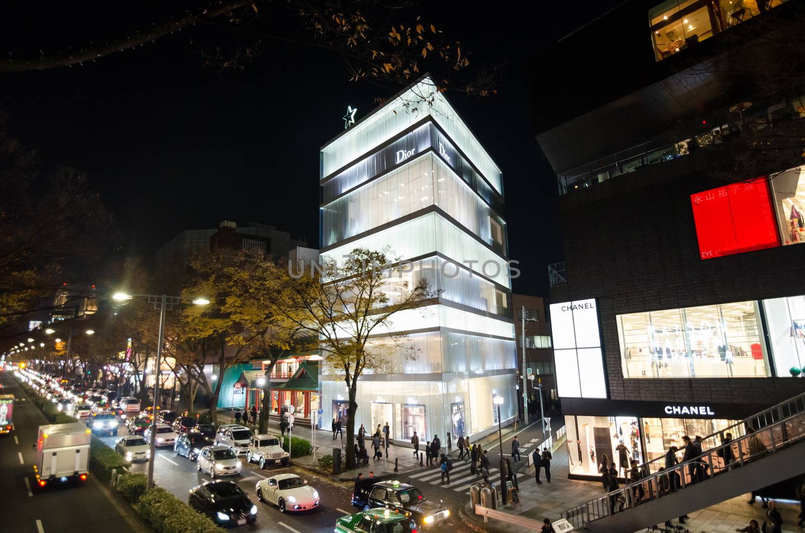 Tokyo, Japan - November 24, 2013: Tourists shopping on Omotesando Street at night on November 24. 2013, Omotesando street sometimes referred to as Tokyo's Champs-Elysees. Here you can find famous brand name shops, cafes and restaurants for a more adult clientele. 