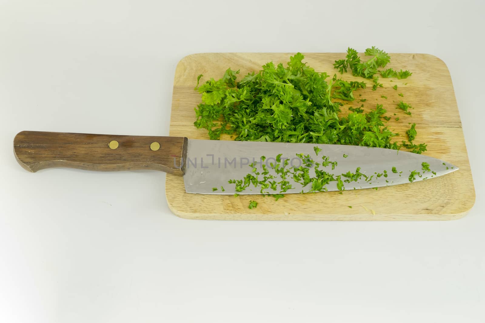 chopped parsley on cutting board with knife by art9858