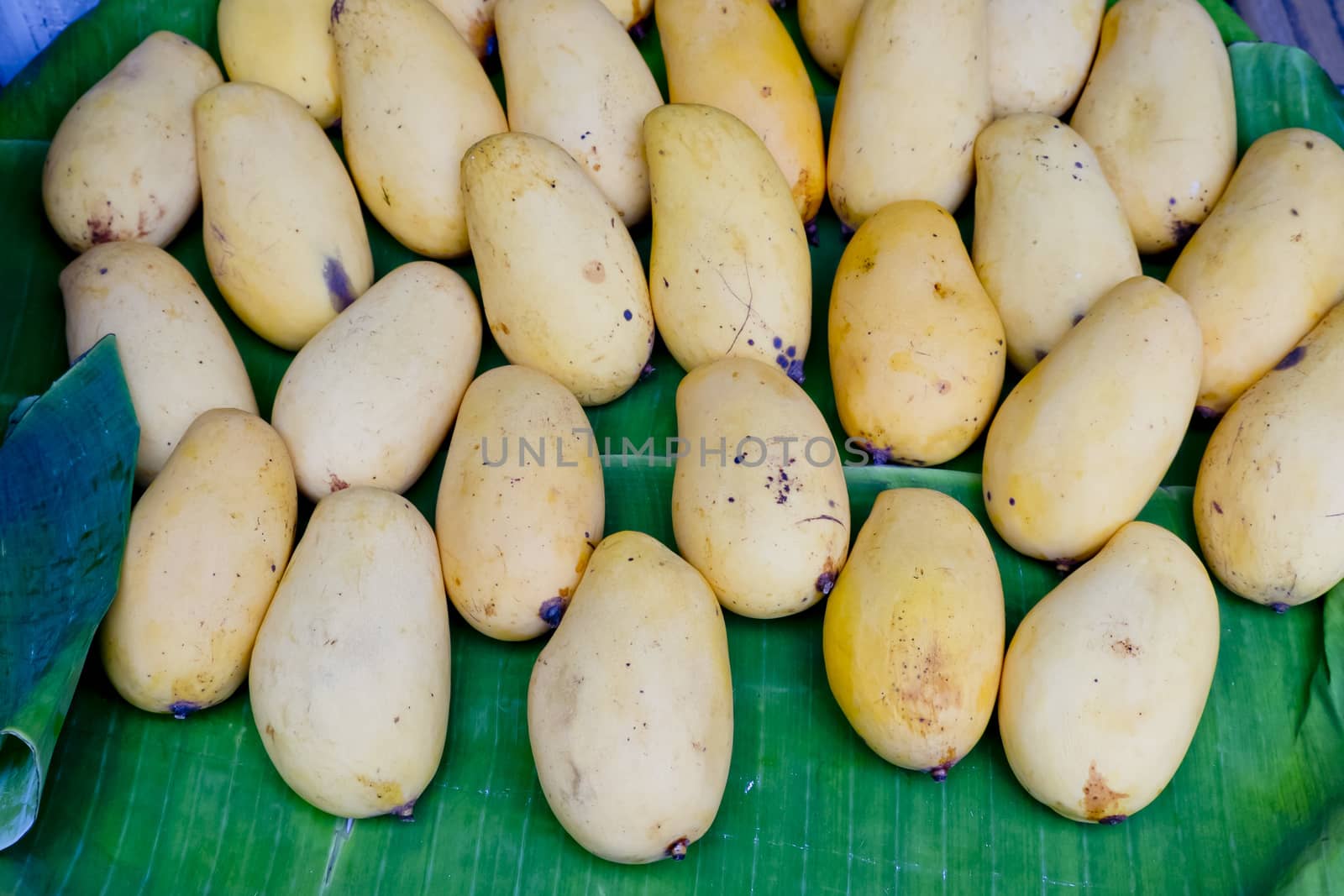 Yellow mango on banana leaf at Thai Market by art9858