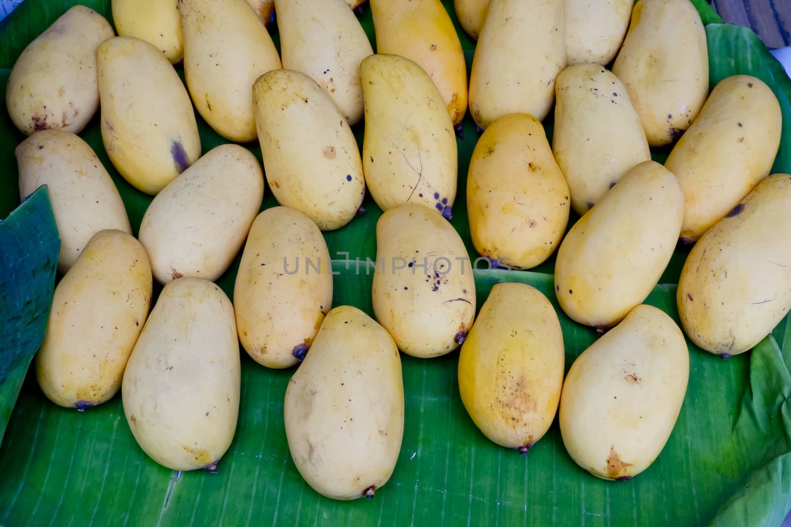 Yellow mango on banana leaf at Thai Market by art9858