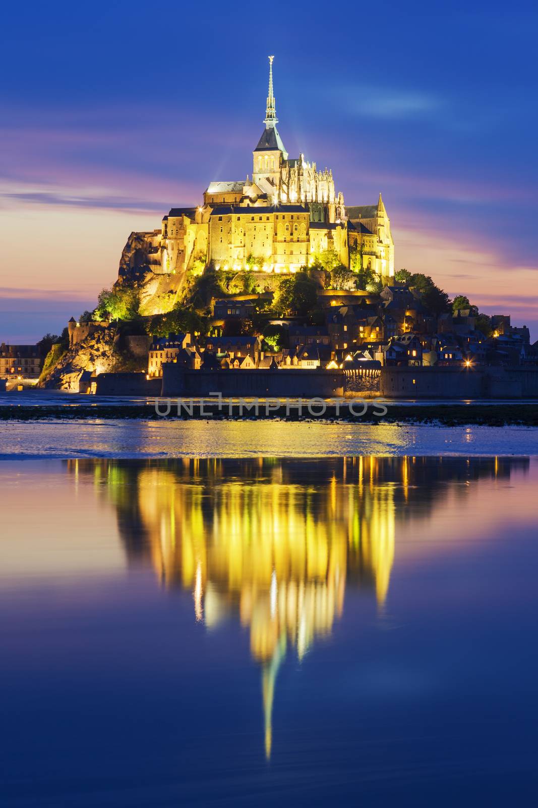 View of famous Mont-Saint-Michel by night, France.