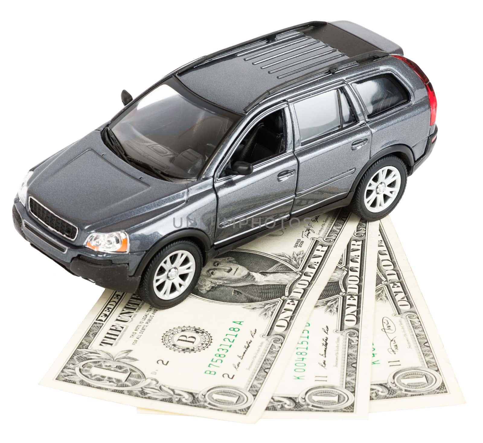 Car standing on money isolated on white background