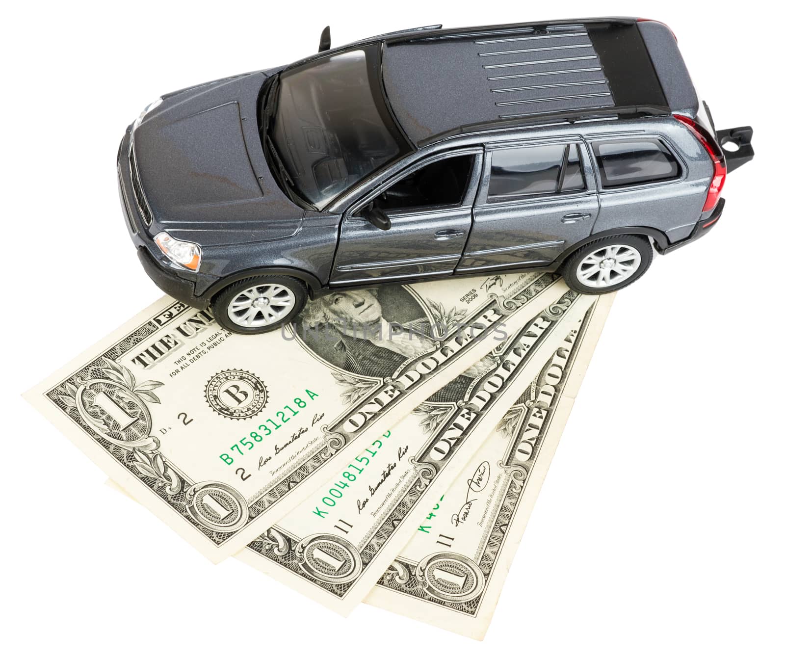 Car standing on dollars isolated on white background