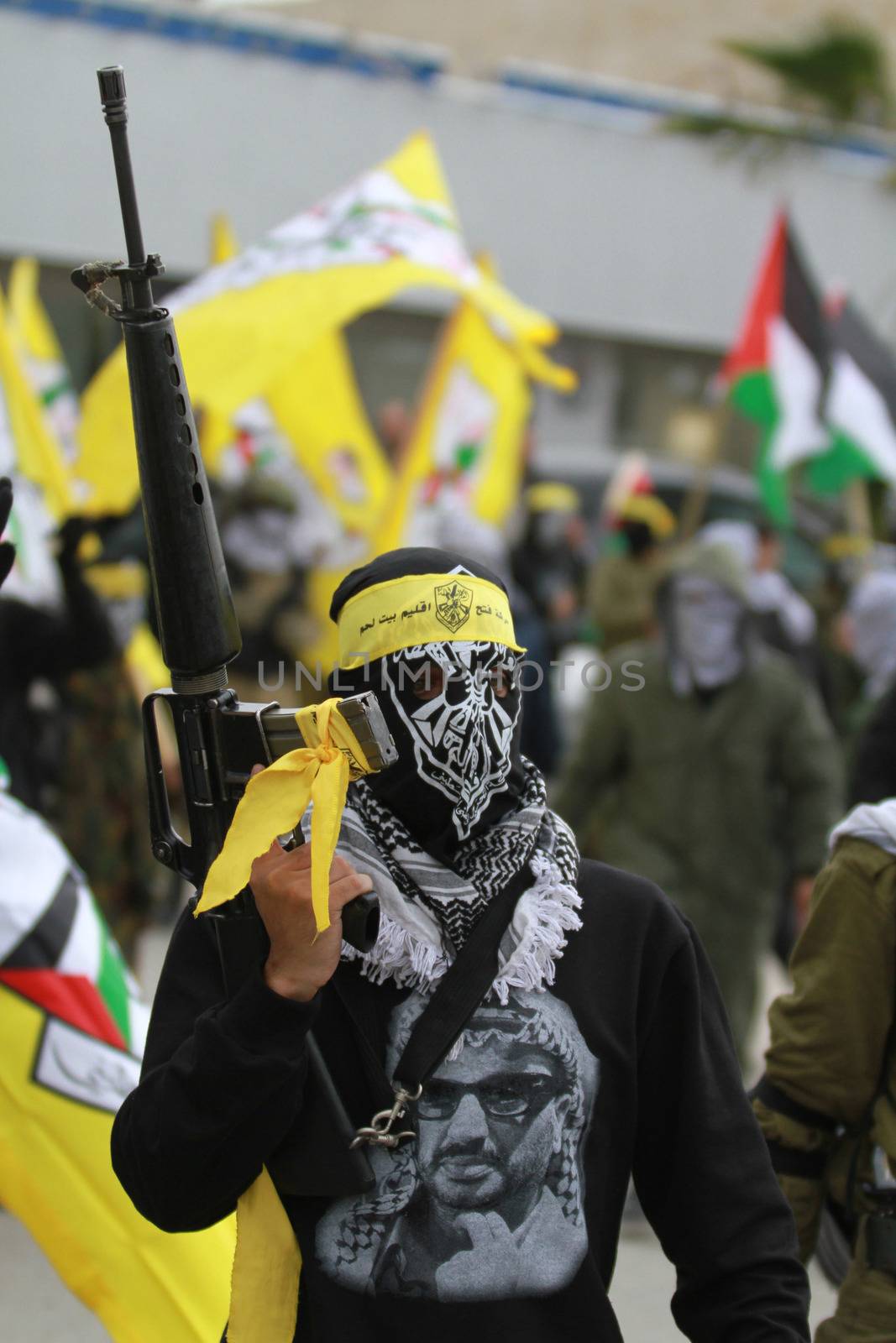 WEST BANK, Bethlehem: Palestinian supporters of the Fatah movement rally in Bethlehem, the West Bank to celebrate the group's 51st anniversary on January 7, 2016. A secular faction of the Palestine Liberation Organization, its members wear masks, while touting guns and flags that bore the party brand at the rally.