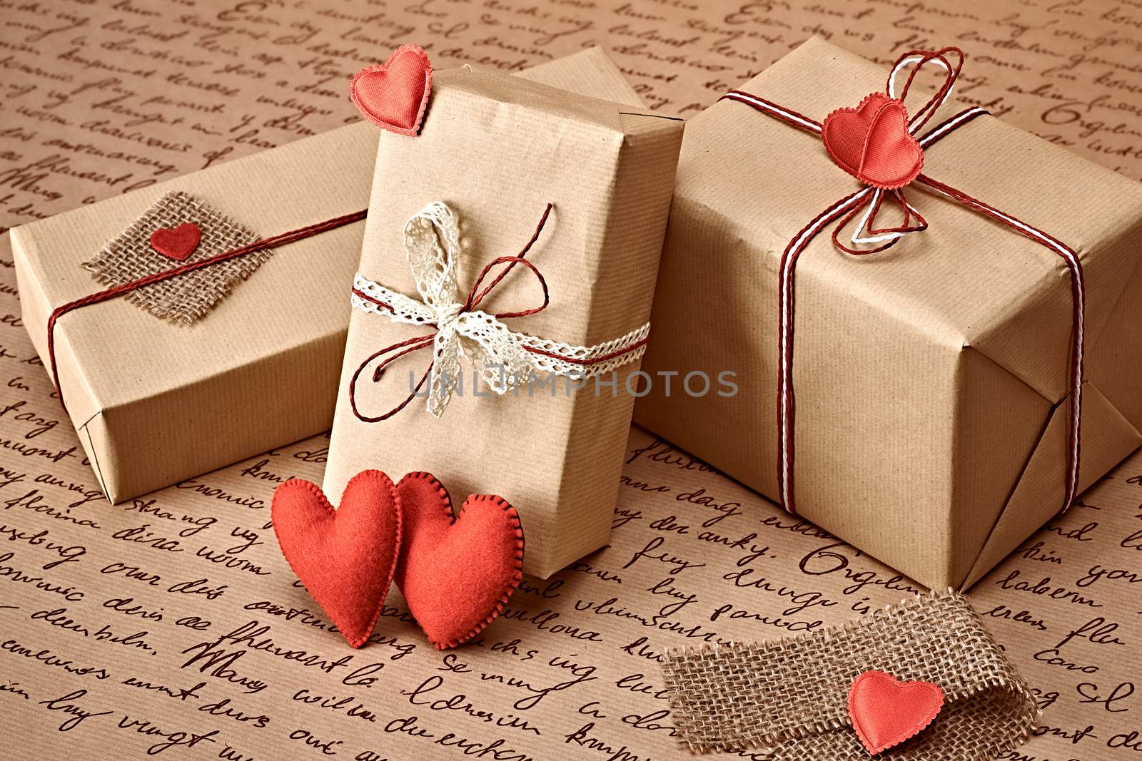 Love hearts, Valentines Day. Handcraft gift boxes, presents. Couple of red felt hearts. Retro romantic styled. Vintage retro concept, unusual greeting card. Kraft paper, copyspase
