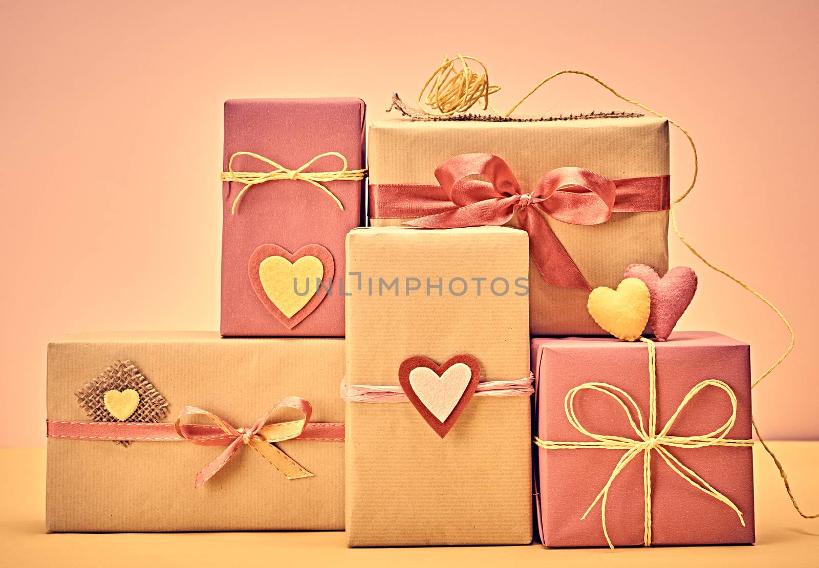 Love hearts, Valentines Day. Handcraft gift boxes, presents stack. Couple of hearts. Retro romantic styled. Vintage retro concept, unusual greeting card. Kraft paper, multicolored felt, copyspase