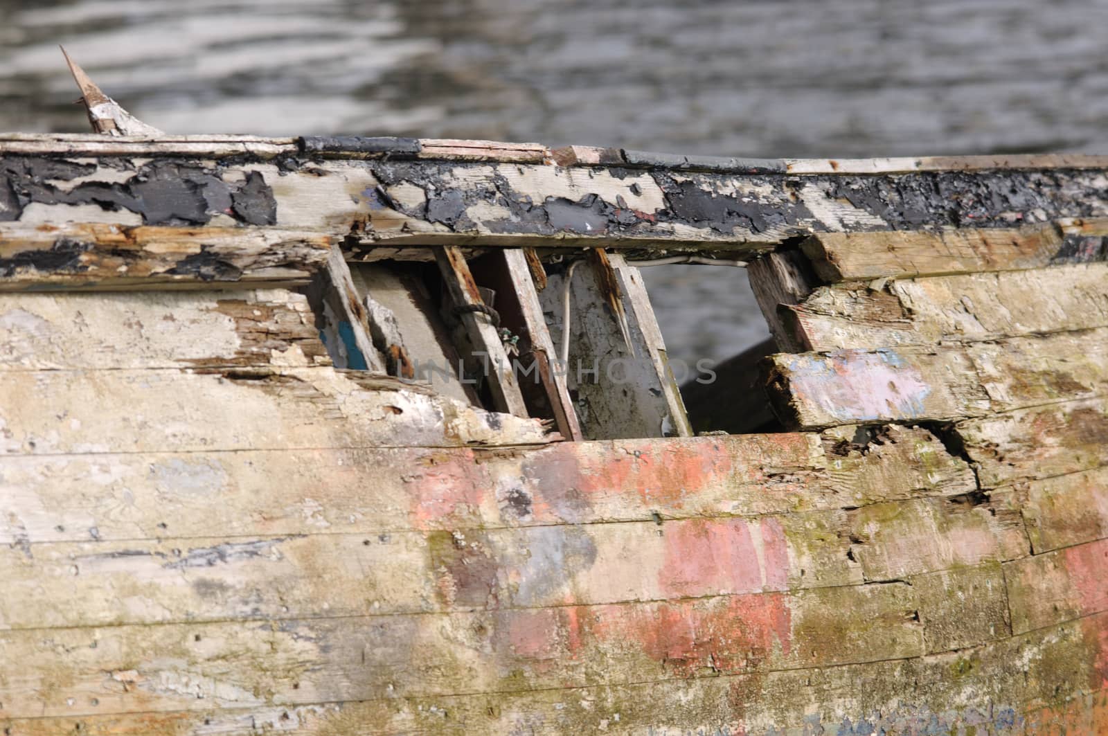 Wreck.

Old and decrepit boat pulled onto land. You would not want to sail in this one.