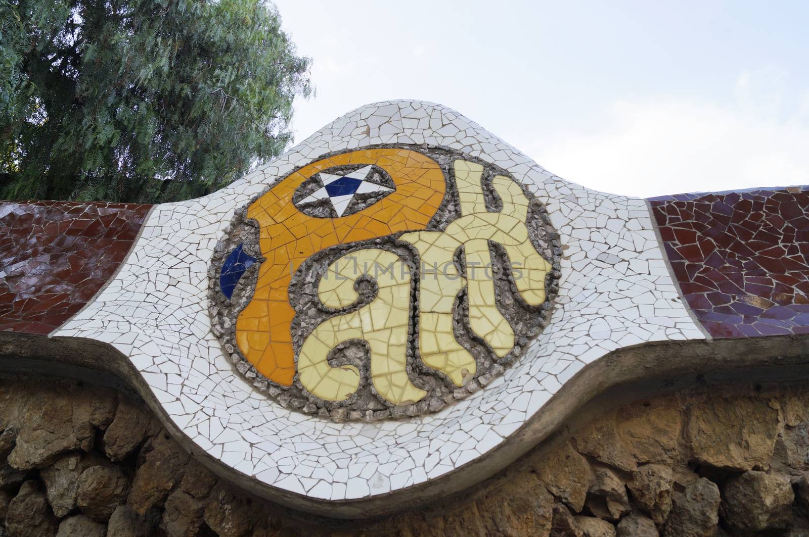 BARCELONA, SPAIN - OCTOBER 08, 2015: Mosaic sign of Park Guell in Barcelona, Spain, designed by famous architect Antoni Gaudi