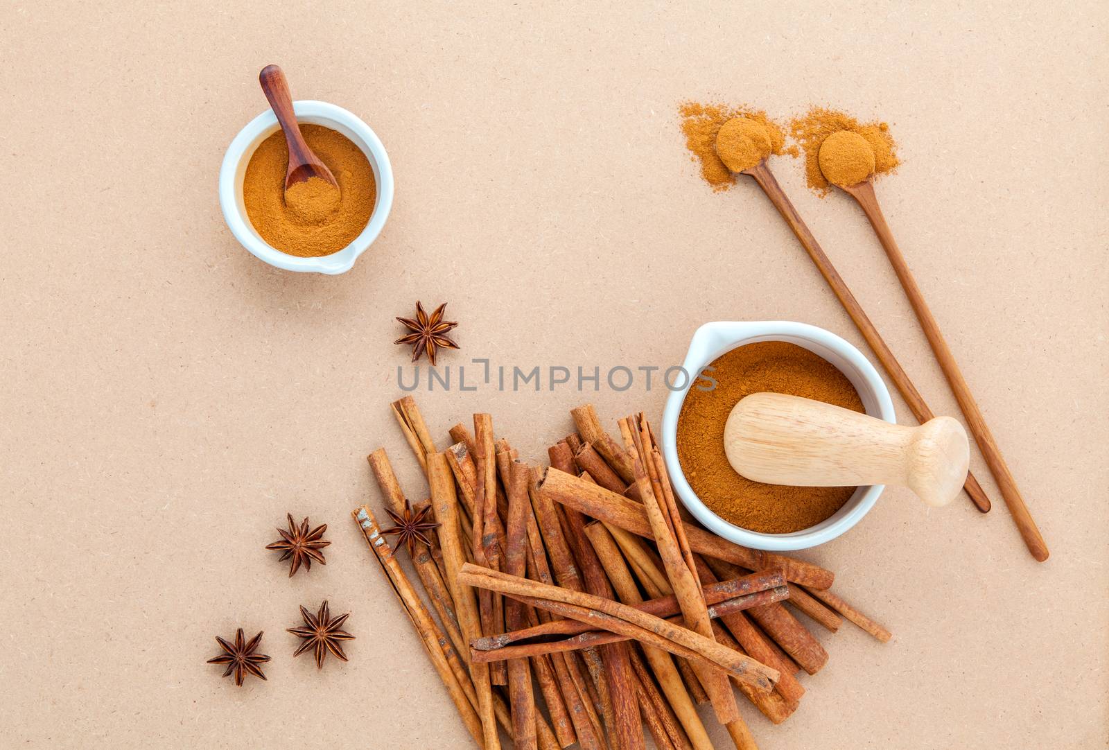 Composition of cinnamon stick and cinnamon powder in white morta by kerdkanno