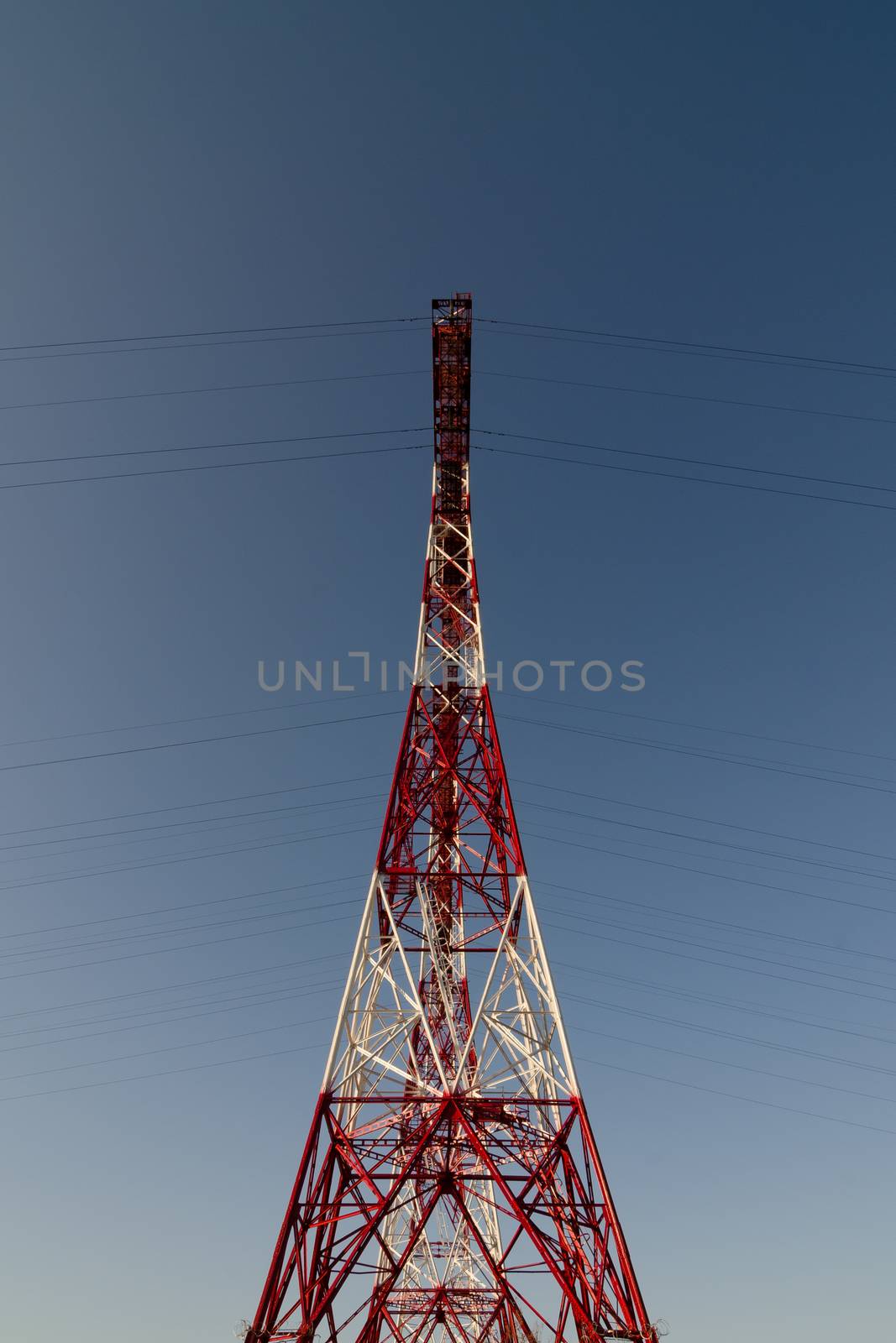 supports of high-voltage power lines against the blue sky