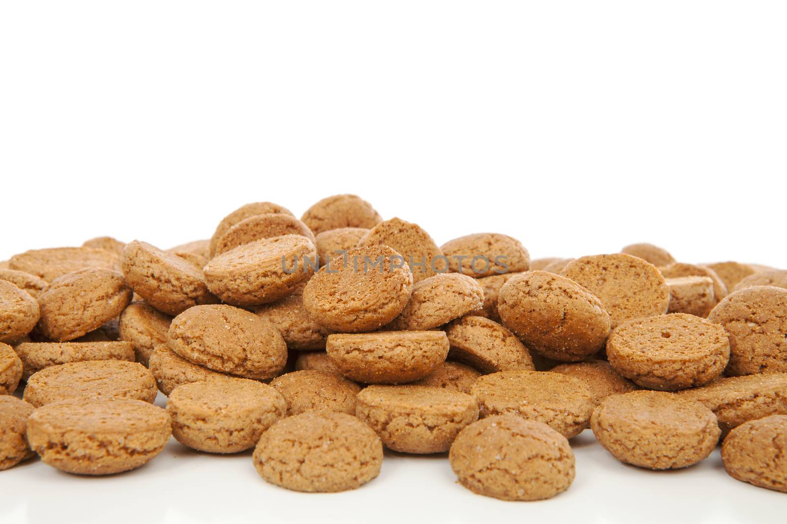 Closeup of typical Dutch sweets: pepernoten (ginger nuts) for Sinterklaas; celebration at 5 december in the Netherlands over white background