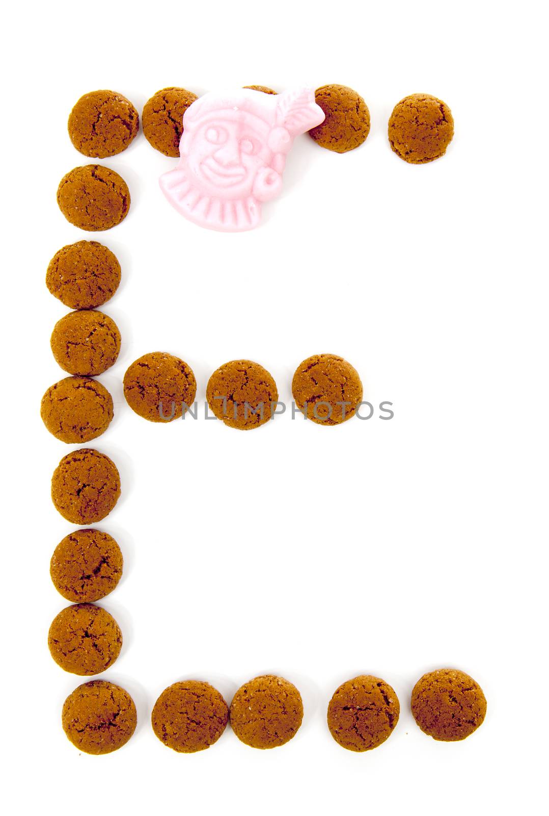 Ginger nuts, pepernoten, in the shape of letter E isolated on white background. Typical Dutch candy for Sinterklaas event in december