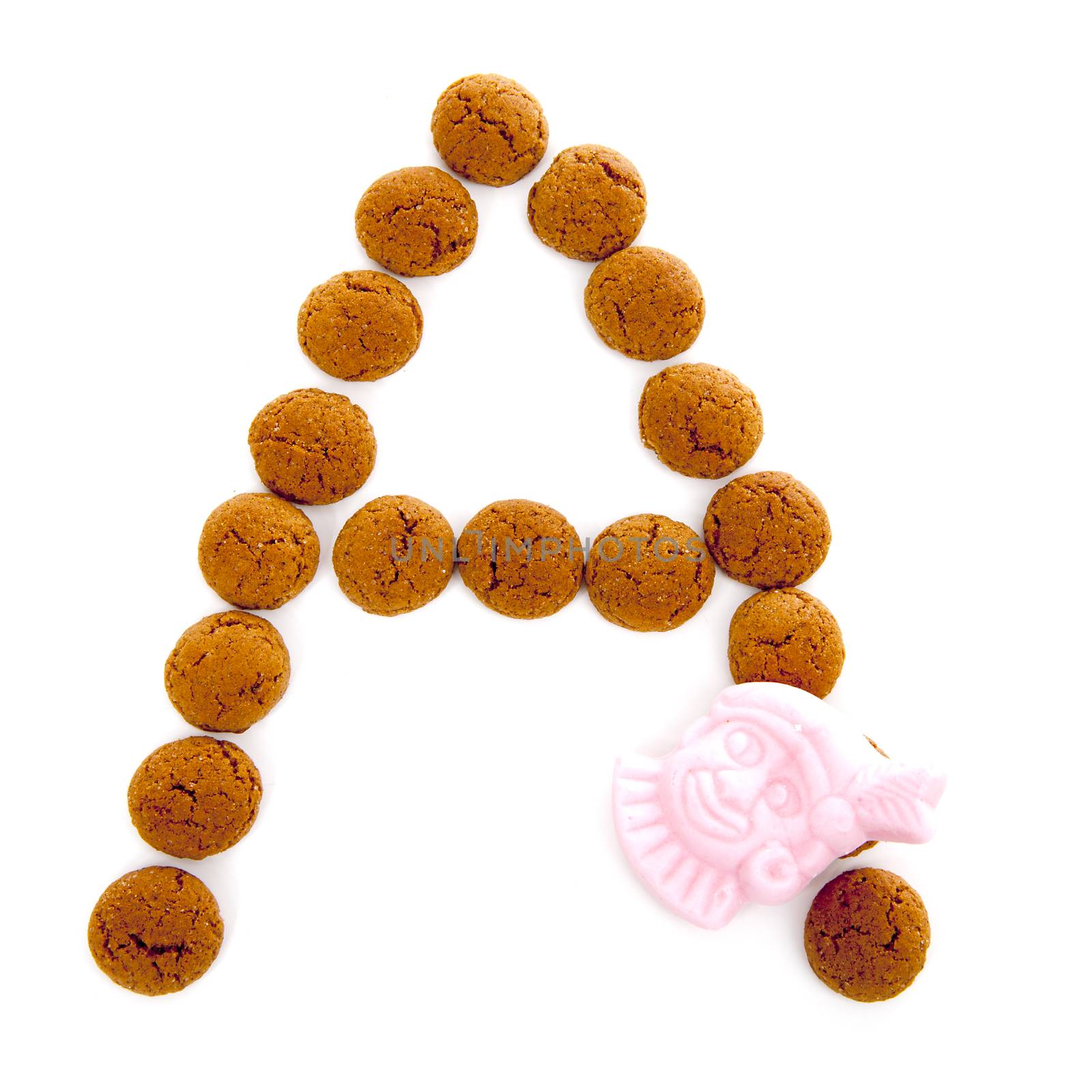 Ginger nuts, pepernoten, in the shape of letter A isolated on white background. Typical Dutch candy for Sinterklaas event in december