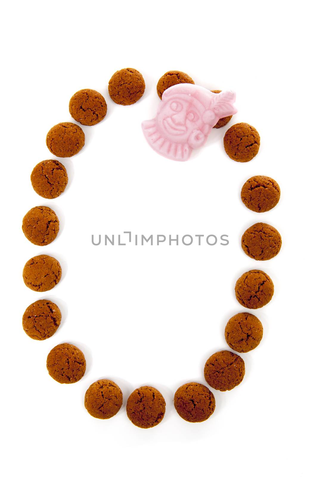 Ginger nuts, pepernoten, in the shape of letter O isolated on white background. Typical Dutch candy for Sinterklaas event in december