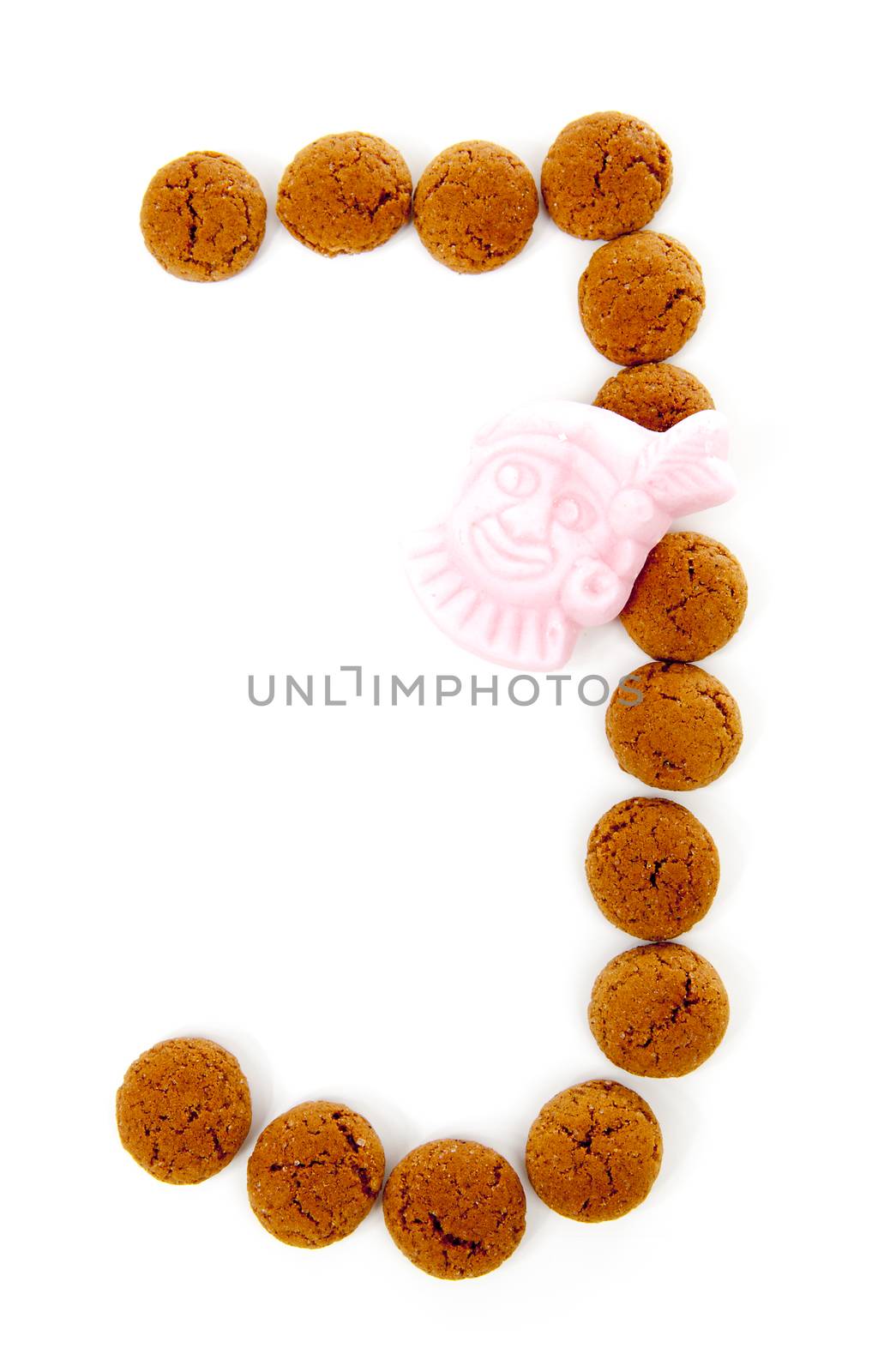 Ginger nuts, pepernoten, in the shape of letter J isolated on white background. Typical Dutch candy for Sinterklaas event in december