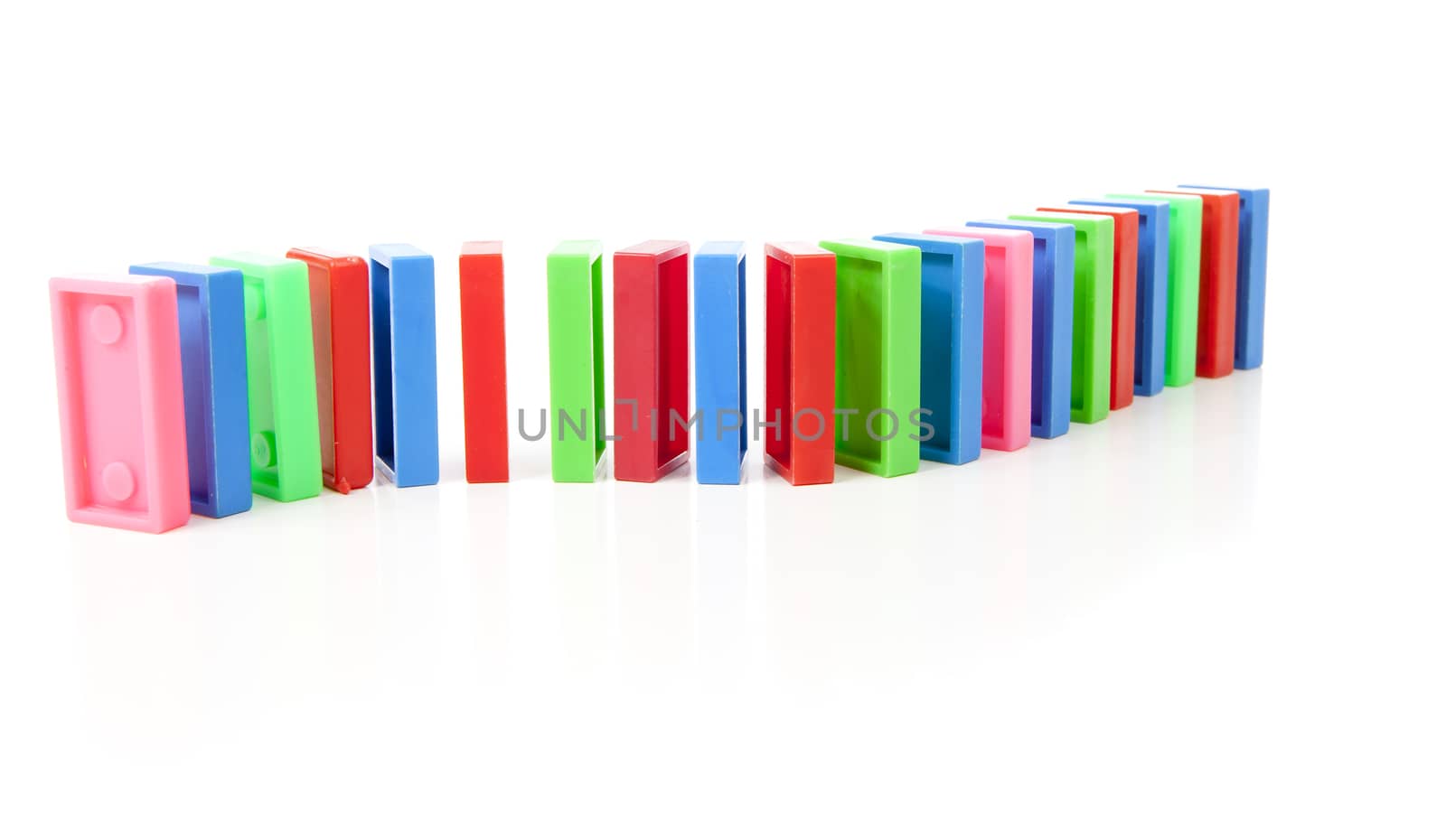 colorful domino bricks in a row isolated on white background