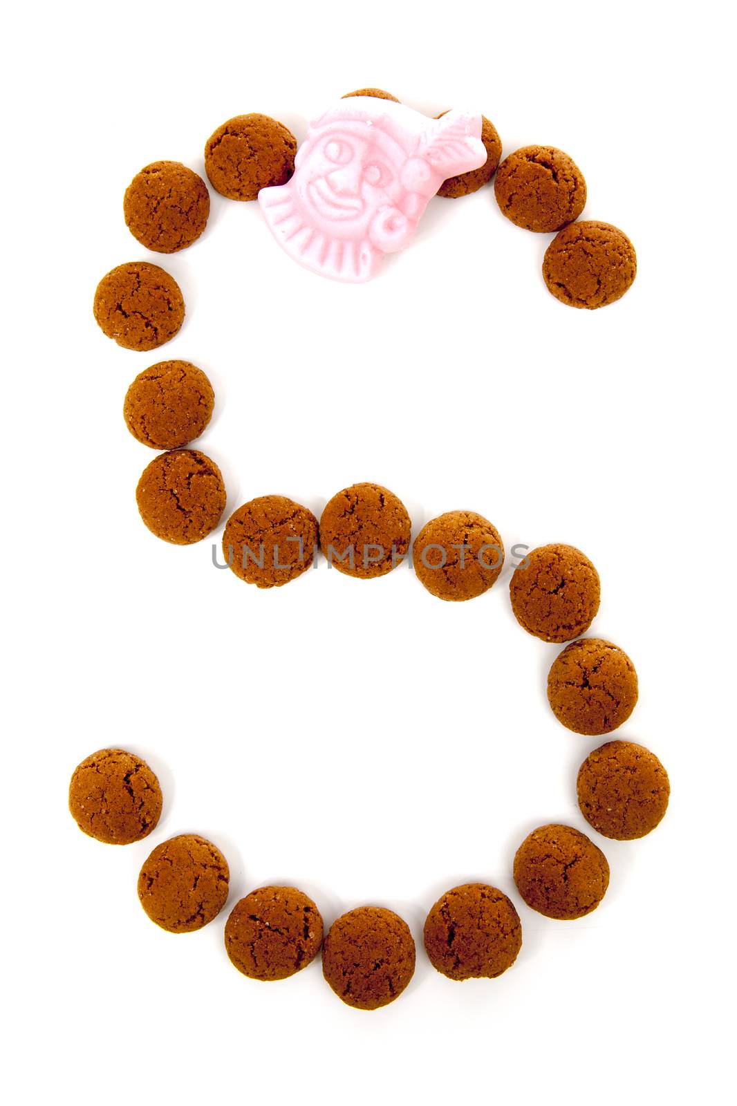 Ginger nuts, pepernoten, in the shape of letter S isolated on white background. Typical Dutch candy for Sinterklaas event in december