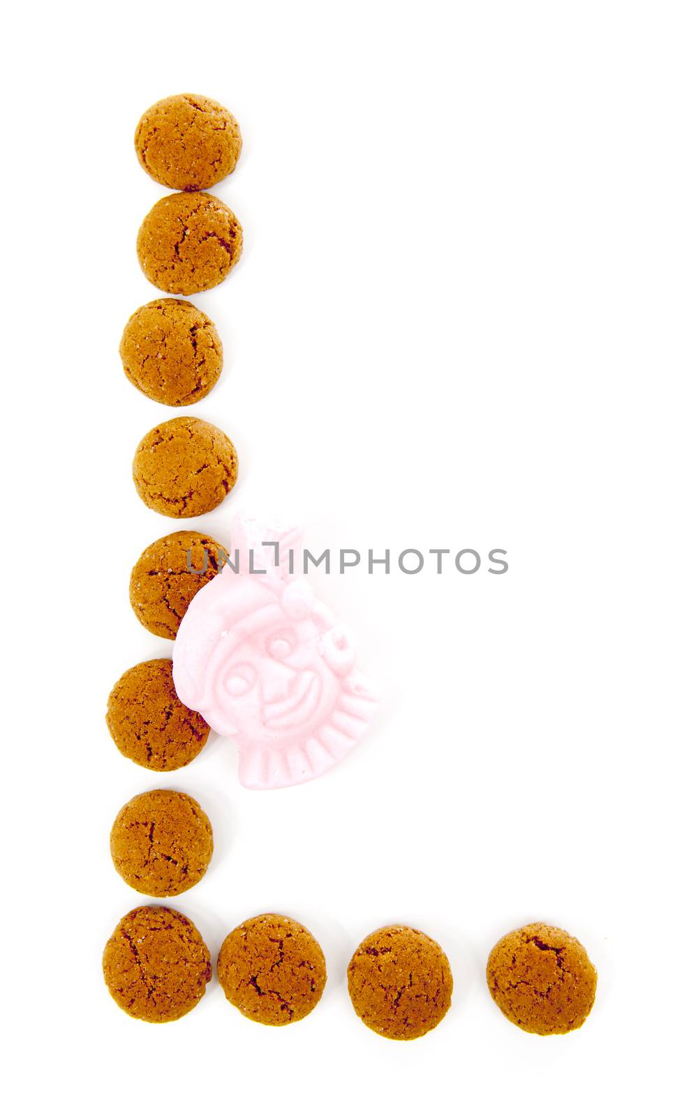Ginger nuts, pepernoten, in the shape of letter L isolated on white background. Typical Dutch candy for Sinterklaas event in december