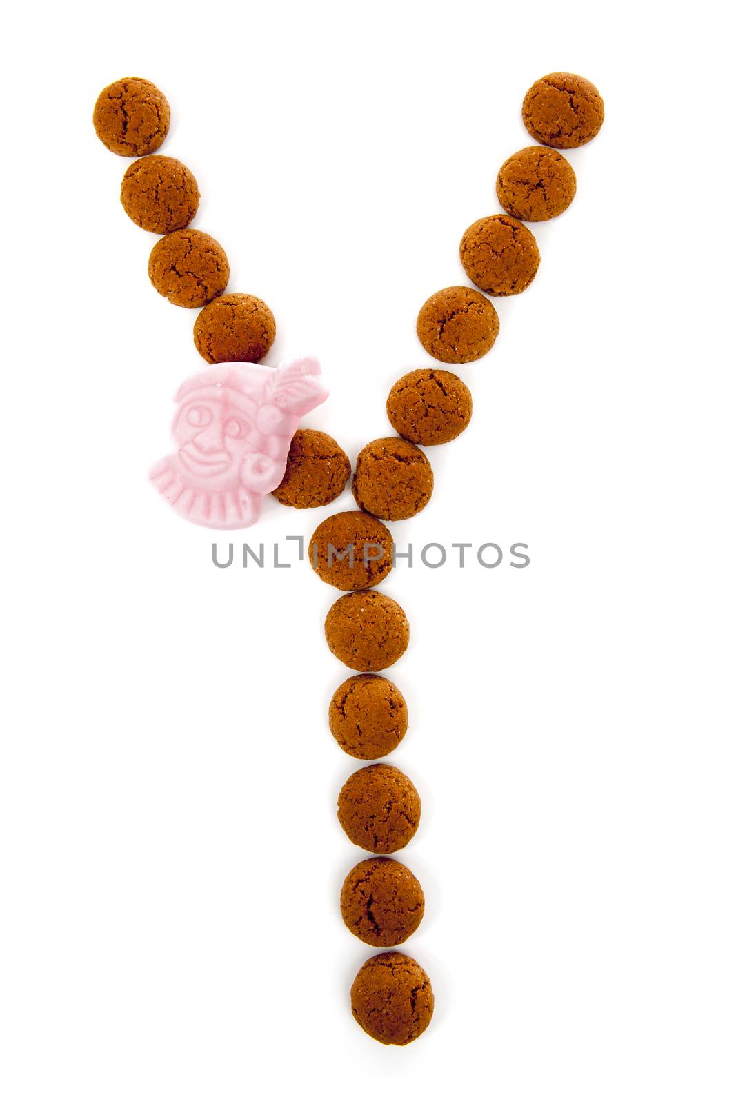 Ginger nuts, pepernoten, in the shape of letter Y isolated on white background. Typical Dutch candy for Sinterklaas event in december