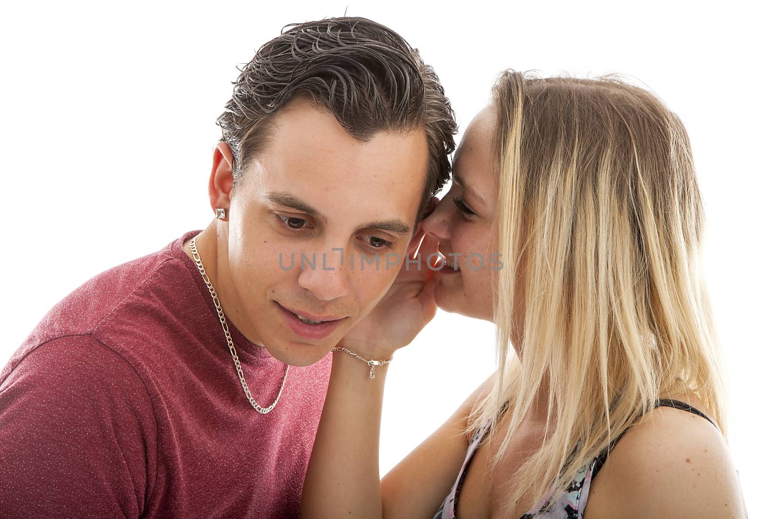 girl is whispering in ear of boyfriend isolated on white background