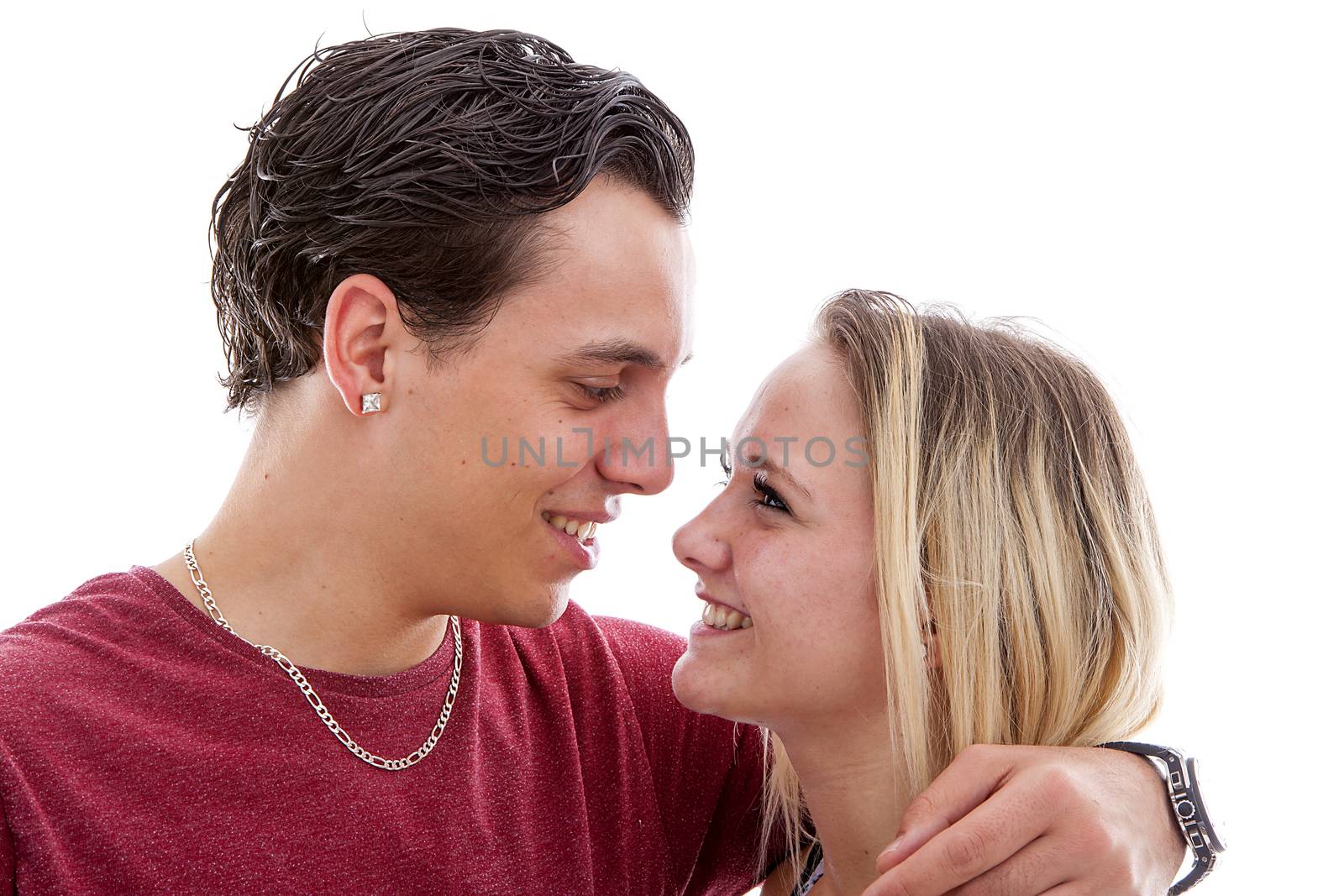 Young couple in love over white background looking at each other
