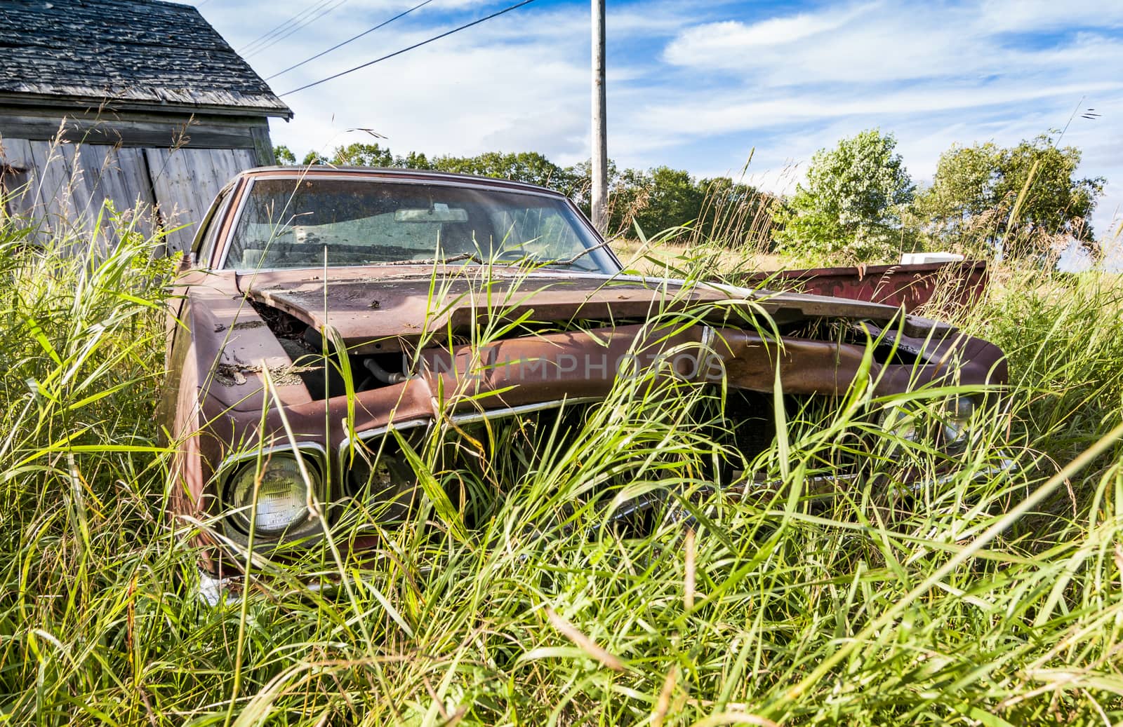old wrecking car in countryside in Maine, Usa
