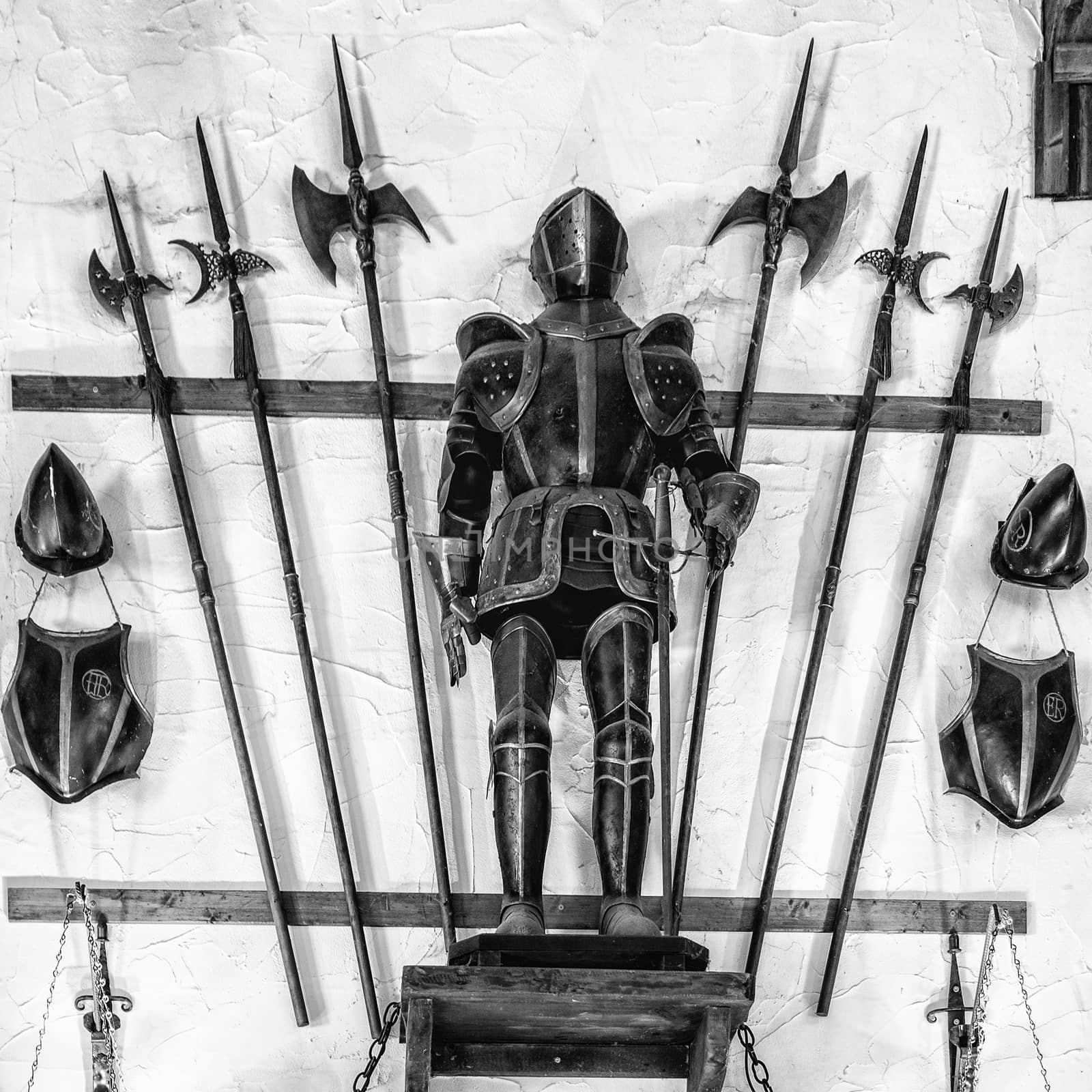 Medieval armor exposed along with metal halberds.