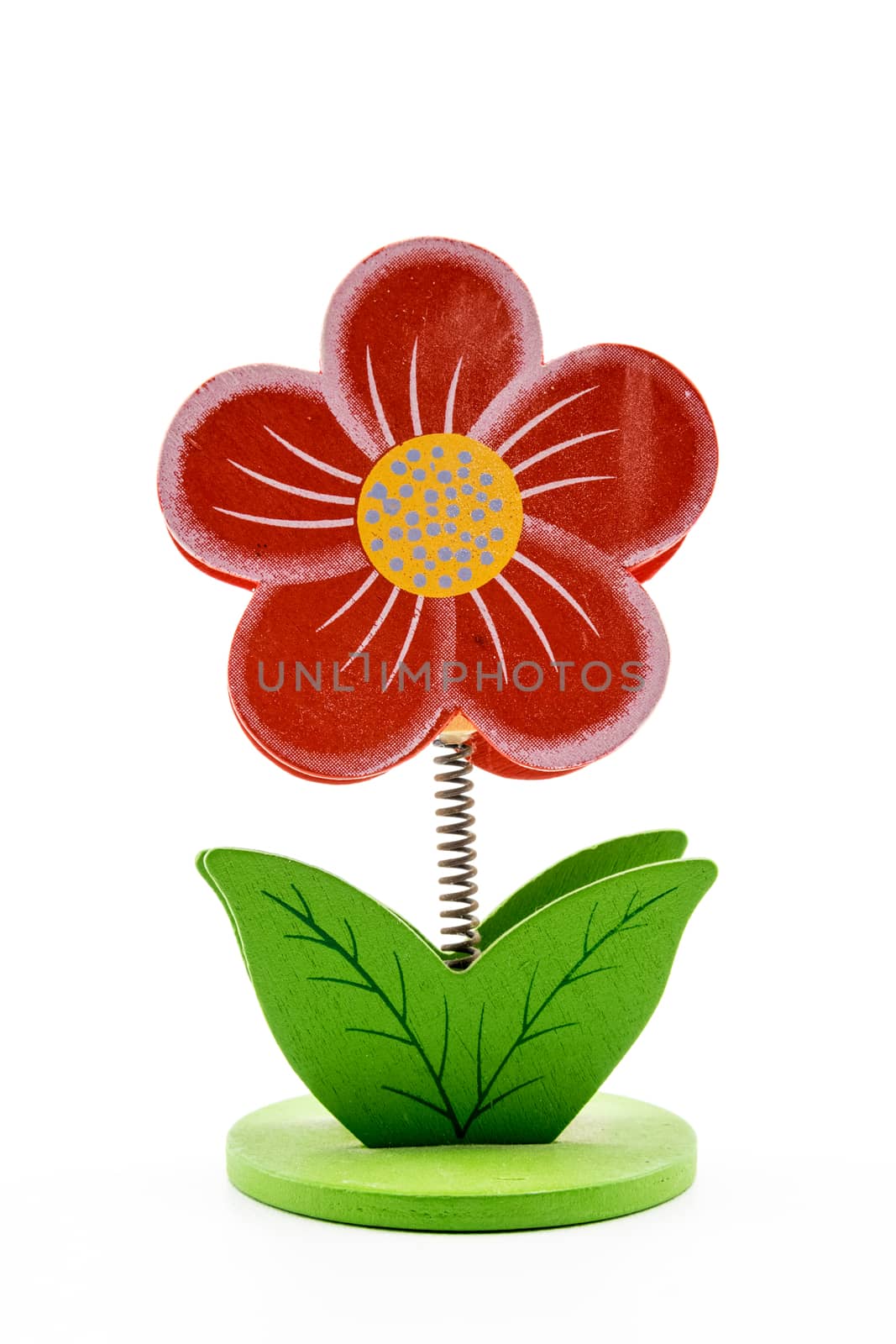 Red wooden flower with stem formed by a spring on white background.