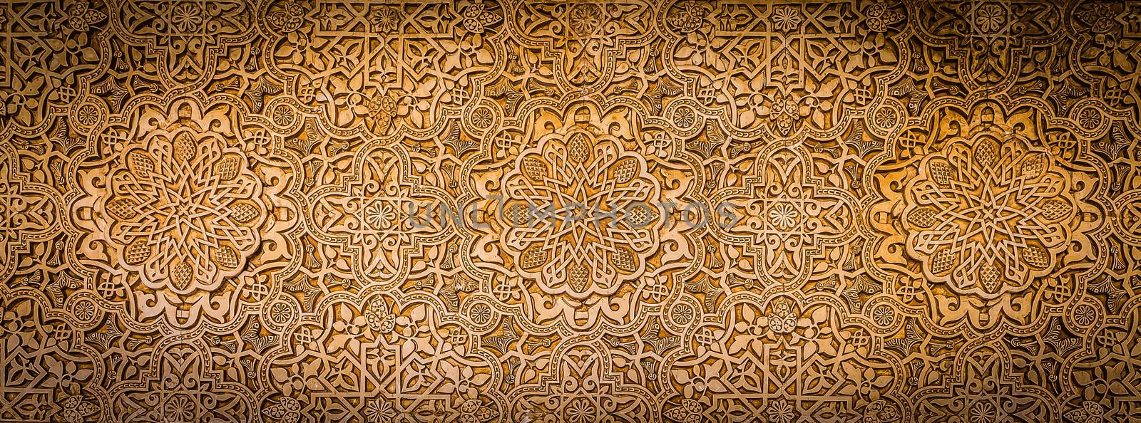 Wall detail of Alhambra UNESCO site in Granada - South of Spain. 600 years old arabic characters.