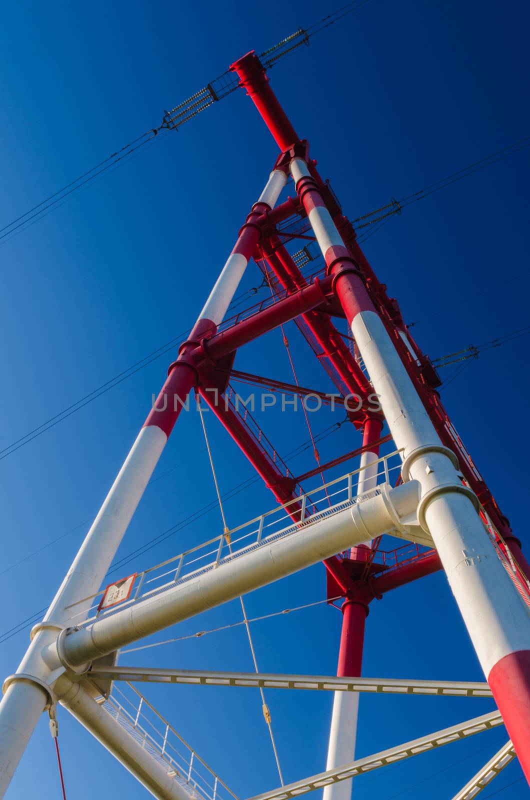 supports of high-voltage power lines against the blue sky