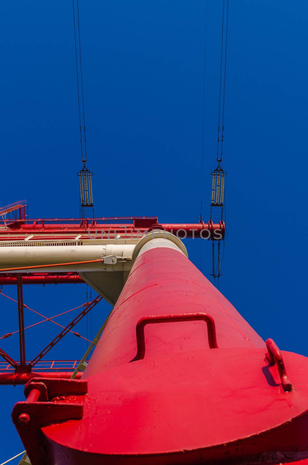 supports of high-voltage power lines against the blue sky