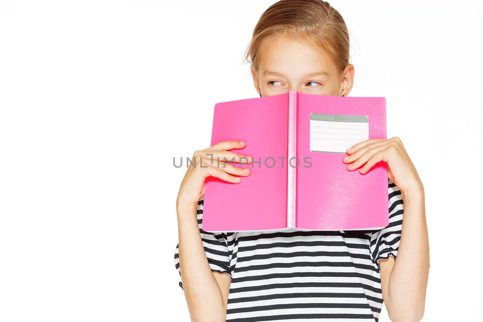 Beautiful little girl in blue dress with copybook. Isolated on white.