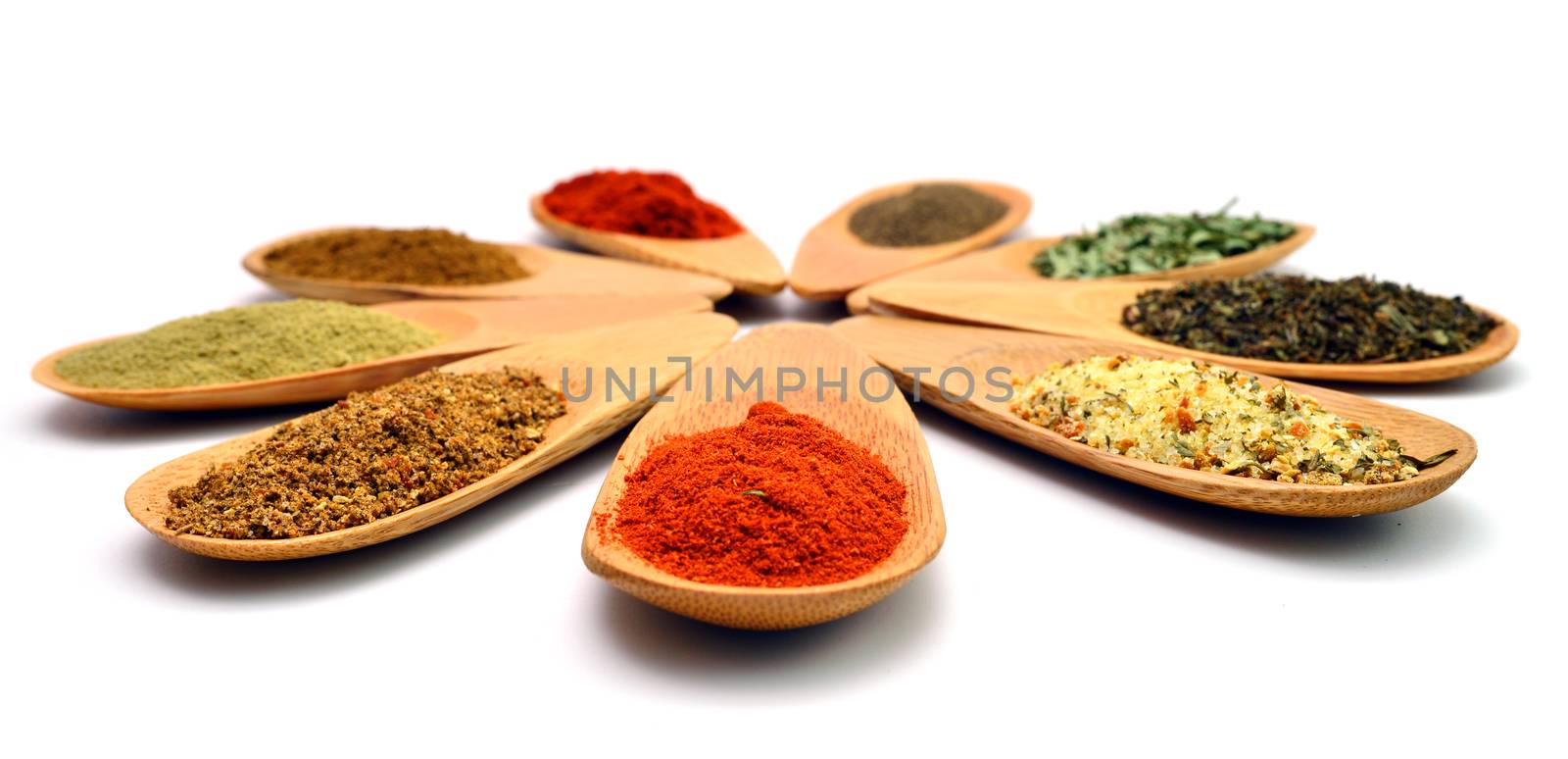 wooden food spice spoons over white background