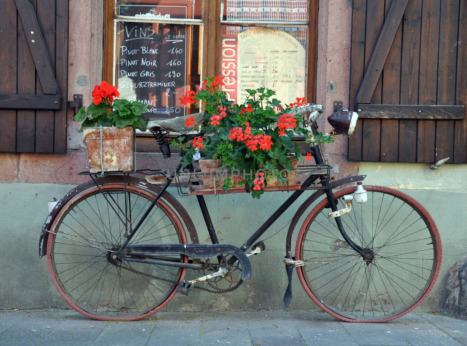 An old bike outside a French Cafe in Alsace in eastern France, but typical of French rural cafes throughout the land.
