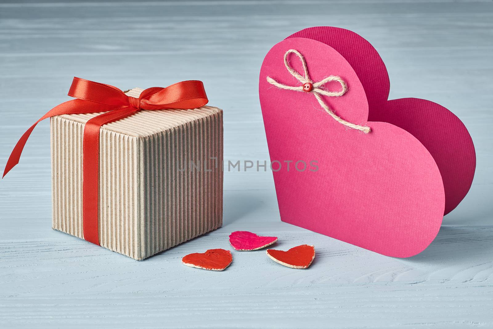 Valentines Day. Love heart, gift box, red ribbon handmade  paper card. Vintage retro romantic style. Marriage proposal concept. Unusual creative greeting card, wooden blue background, copyspace, toned