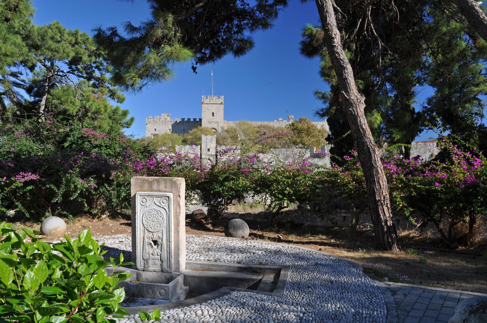 Palace of the Grand masters viewed from Dimokratias lookng across Old Town Moat near Saint Georges Gate, Rhodes Tow, Rhodes Island, Greece