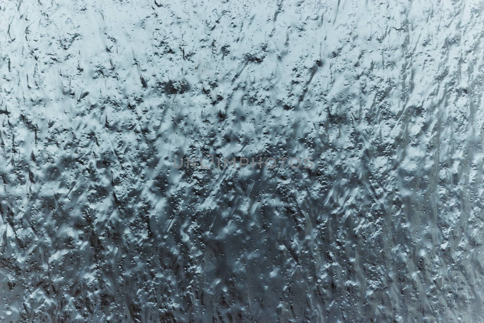 Splashes of ice frozen rain on glass