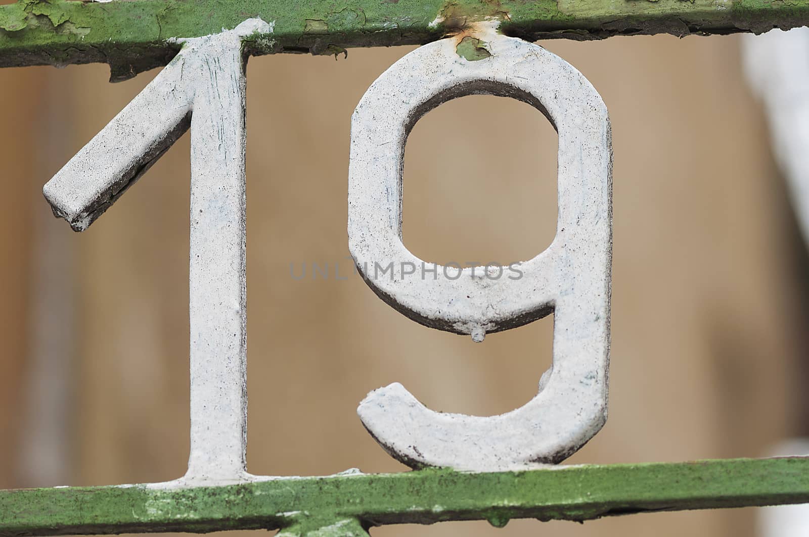 Number 19 on gate. Decoration on a fence. Exterior