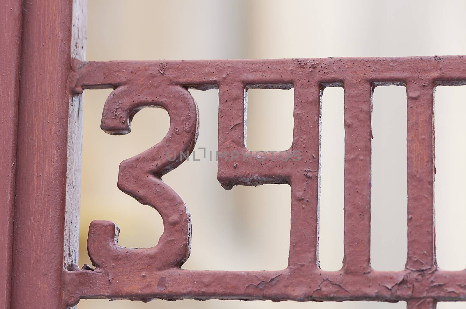 Number 34 on gate. Decoration on a fence. Exterior