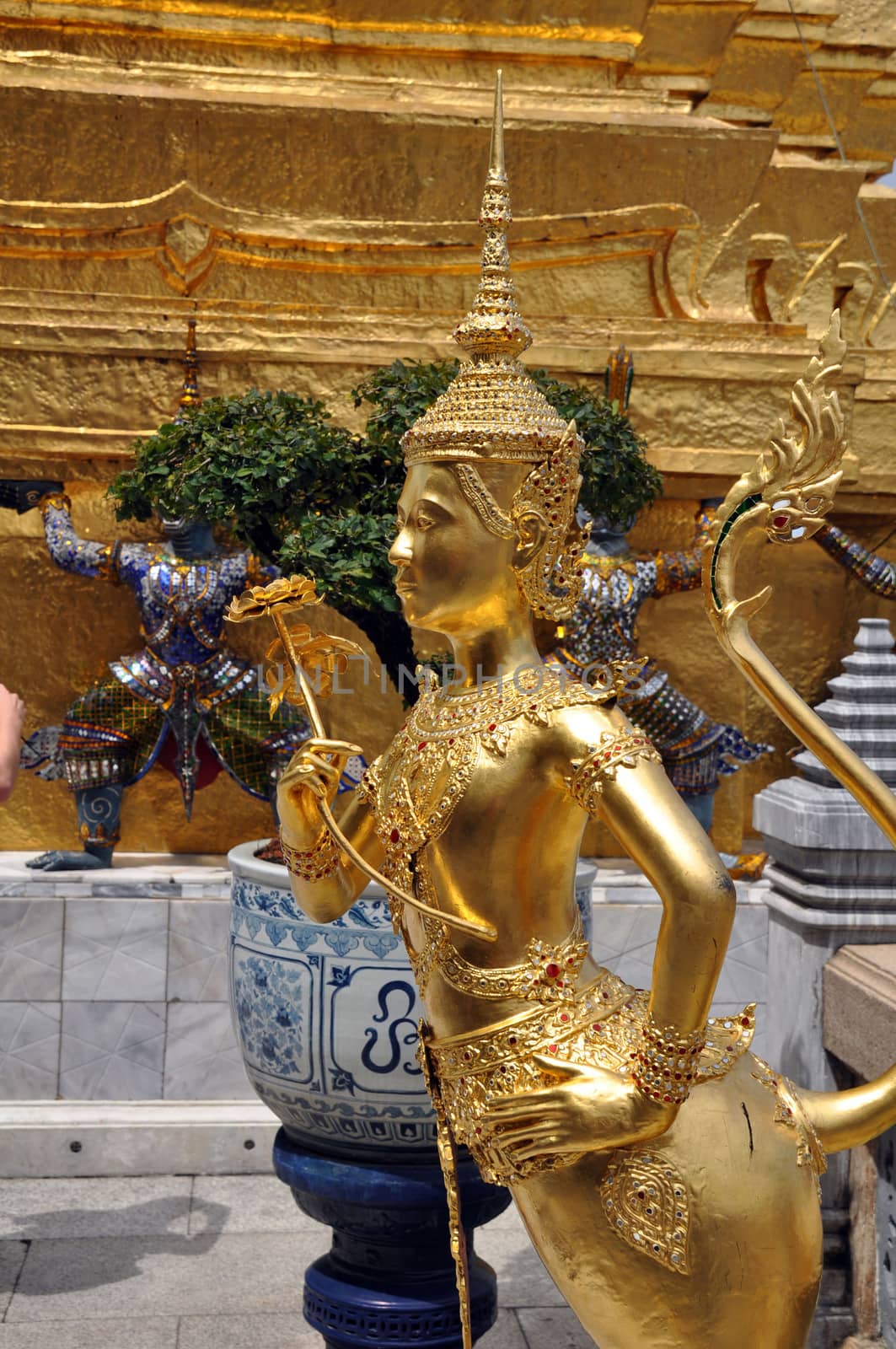 Apsonsi a mythical half woman half lion Creature one of the beautiful gilded figues on the upper terrace of Wat Phra Kaeo Grand Palace Bangkok