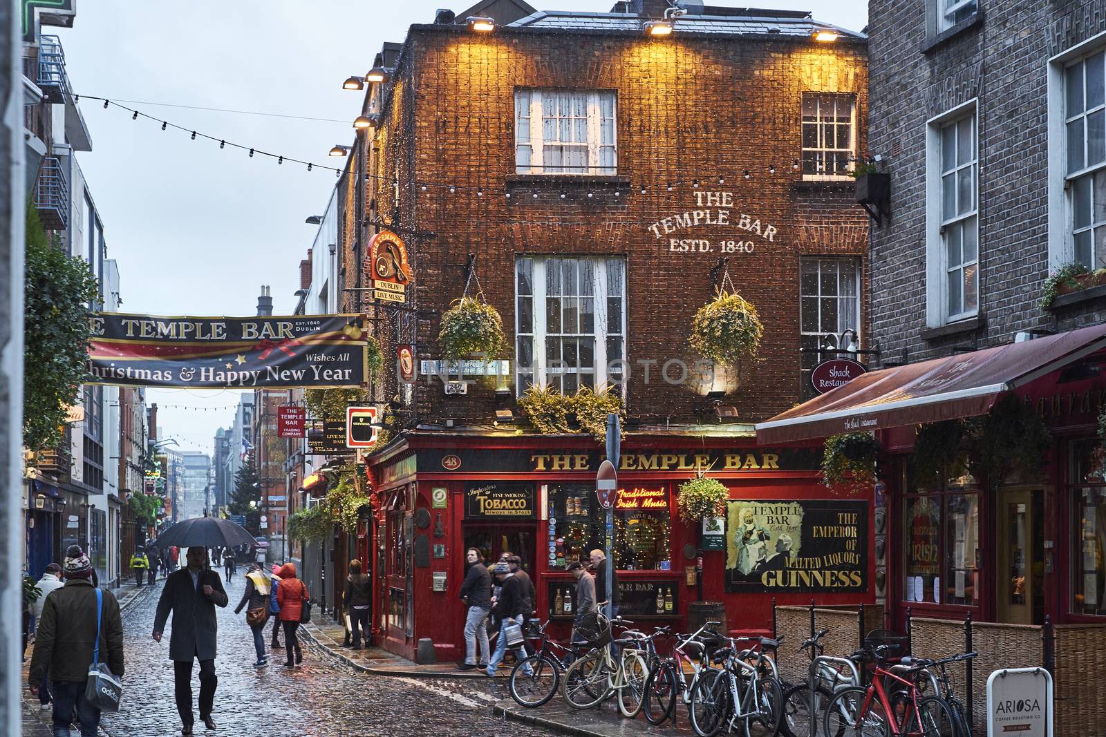 DUBLIN, IRELAND - JANUARY 05: Street in Temple Bar during rainy evening. The area is the heart of tourism in the city. January 05, 2016 in Dublin